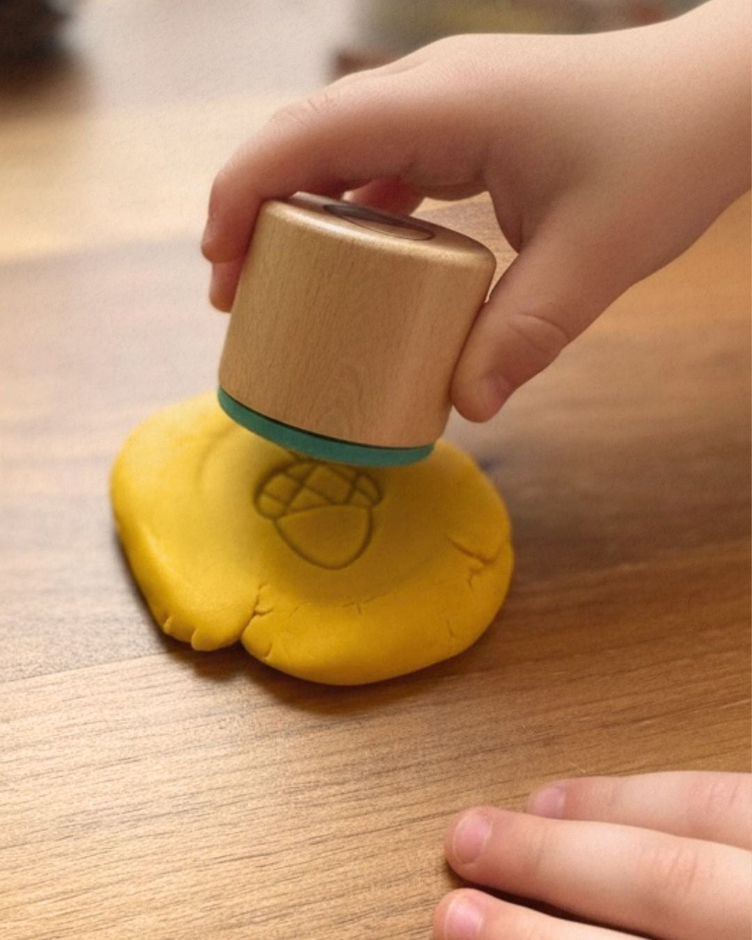 Kinderhand drückt Holzstempel in gelbe Kinderknete – Zendou Kids Waldbox Stempel mit Silikonauflage